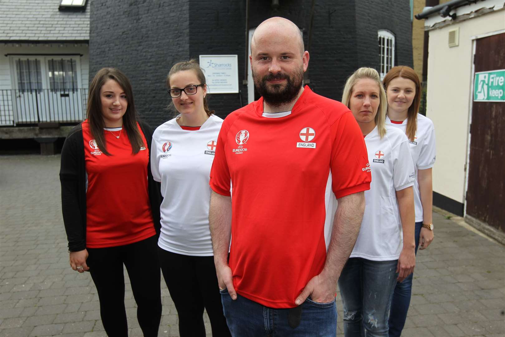 Working from home: Alan Doucy and the staff of Sharrocks. The insurance company has closed its office in Sheerness High Street. Stock photo when the team was kitted out in England kit. Picture: John Westhrop