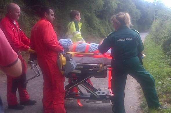Air ambulance crew prepares the horse rider for her flight to hospital after her fall near Tilmanstone. Picture: Brian Mountain