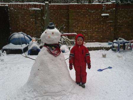 Rhys age 4 with his snowman, built in Lordswood