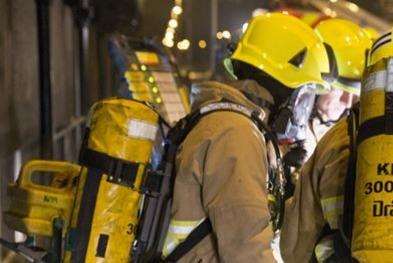 Fire crews used breathing apparatus while fighting the flames, Stock picture