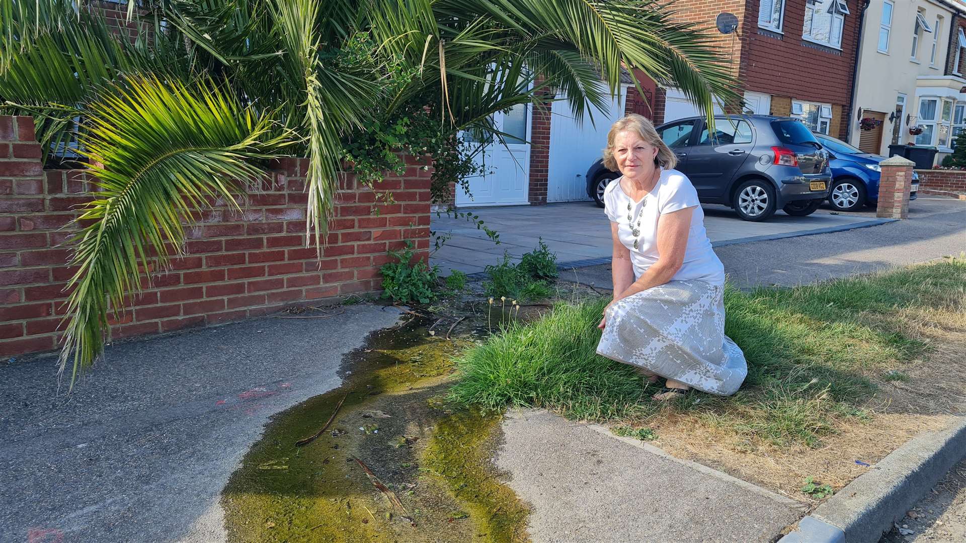 Lynn Harrison with the leak outside her home in Broadstairs