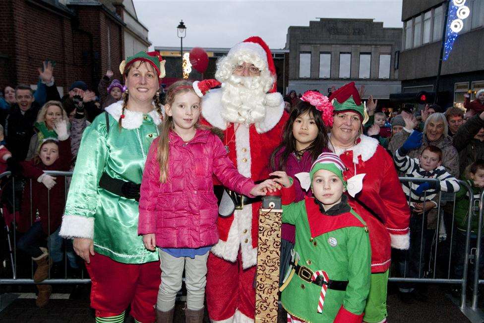 Santa with Minterne school pupils Hollie Hunt and Aaliyah Chin who helped switch the lights on