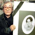 Michael Kyung Woon Lee's father with a poster of the 17-year-old