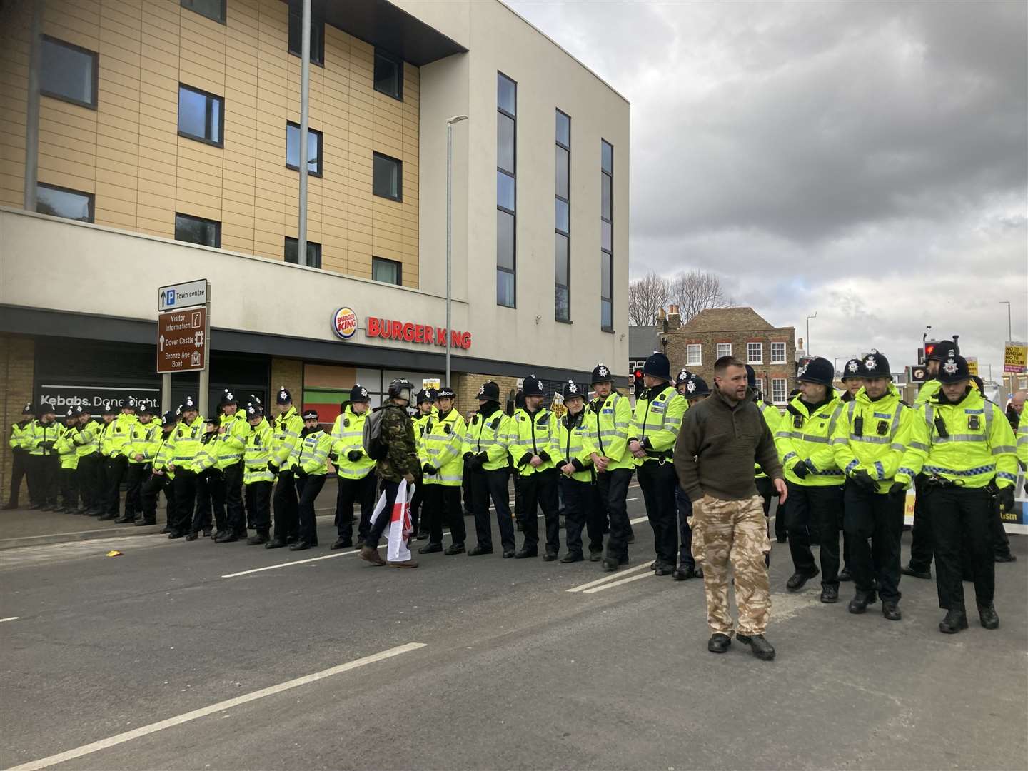 Police form a human chain across the road near the St James' retail park