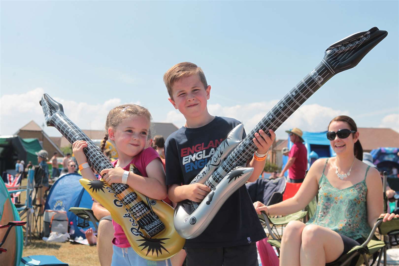 Evie Whittingham, six with her brother, Harry, eight, play air guitar at Iwade Rocks Festival. Picture: John Westhrop