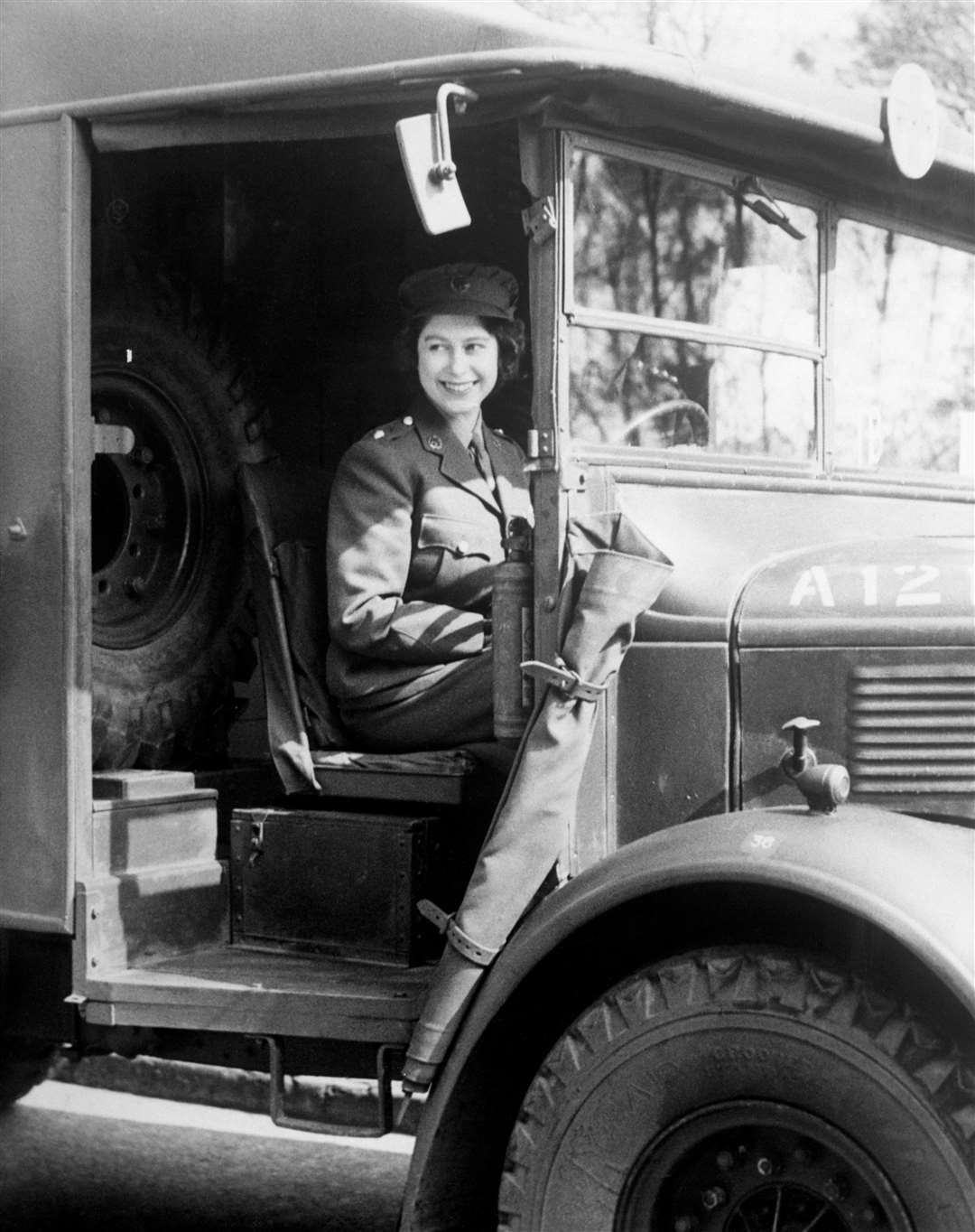 Princess Elizabeth in her uniform at the wheel of an army vehicle while serving in the ATS in 1945 (PA)