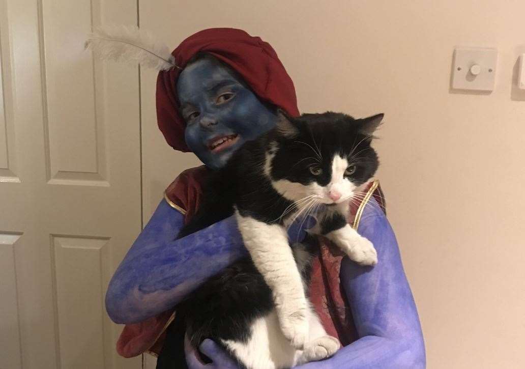 Liam, who is dressed as the Genie from Aladdin, with his much loved pet Ranger. Picture: Keeley Richards