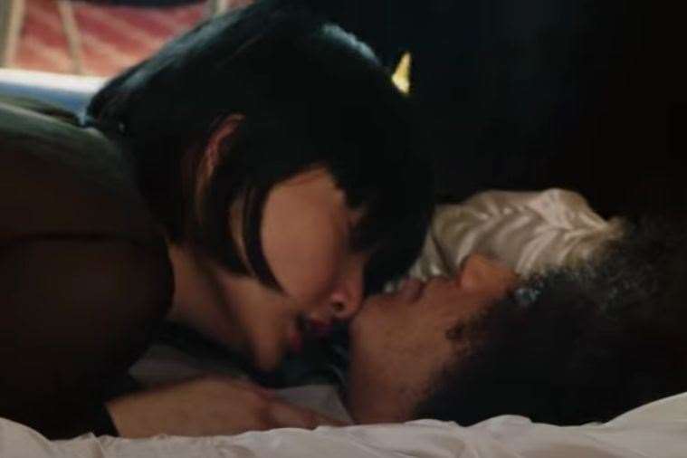 A woman smells a man lying in a coffin in the Lynx advert. Picture: Lynx