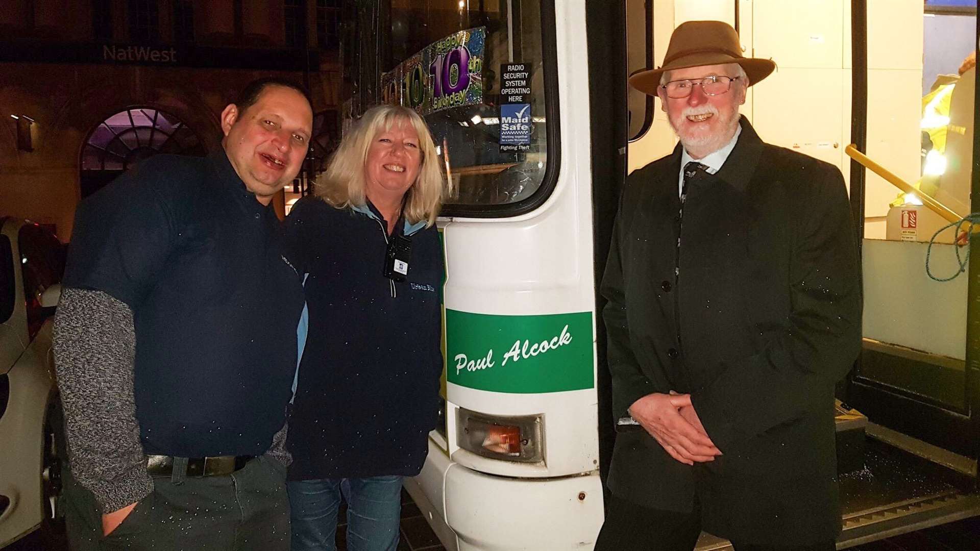 Jon Baker, Val Jacobs and former Urban Blue Bus volunteer Cllr Bryan Vizzard next to Paul Alcock's name on the new bus (9378687)