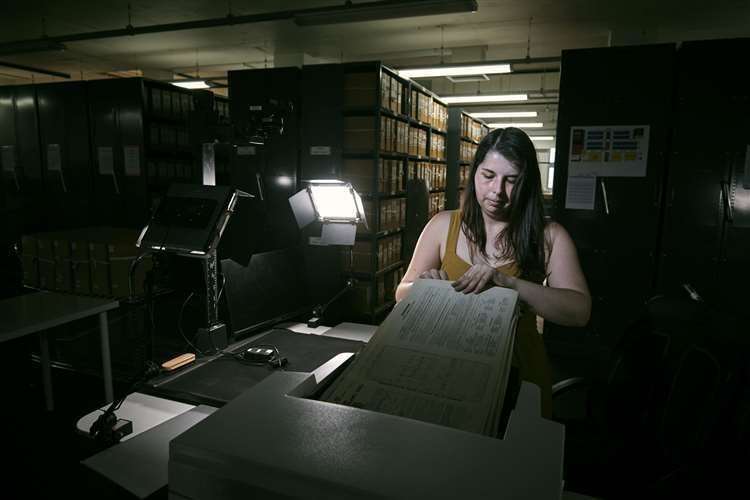 Laura Gowing, a Findmypast technician, scanning individual pages of the 30,000 volumes of the 1921 census (Mikael Buck/Findmypast/PA)