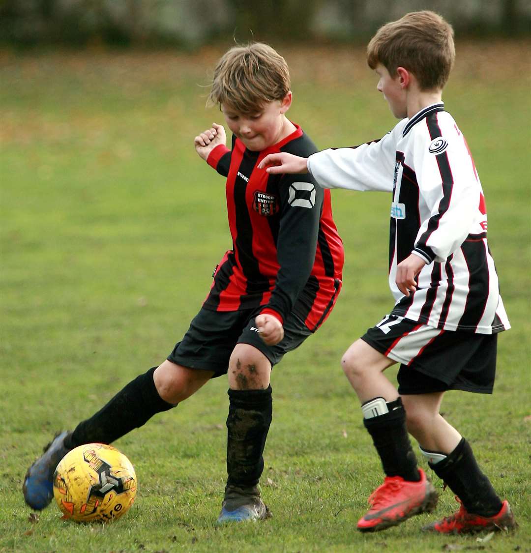 Strood United under-10s are closed down by Milton and Fulston Zebras under-10s. Picture: Phil Lee FM22430291