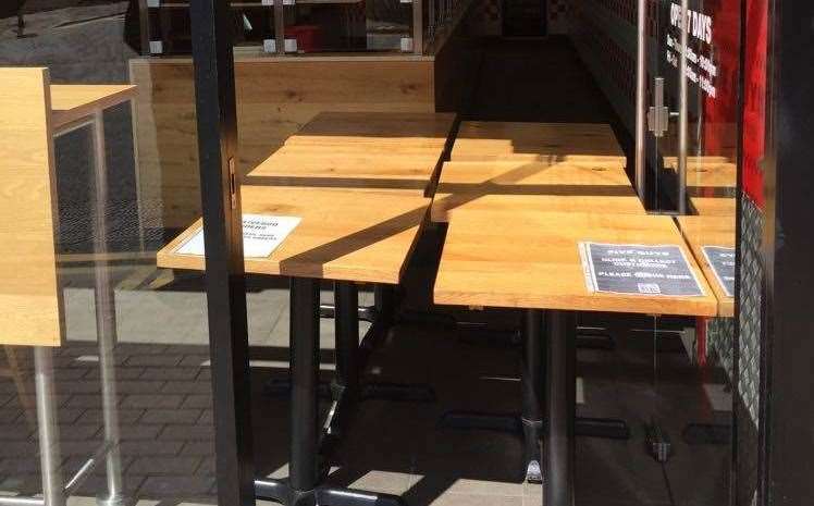 Tables block the doorway, preventing customers from entering the restaurant