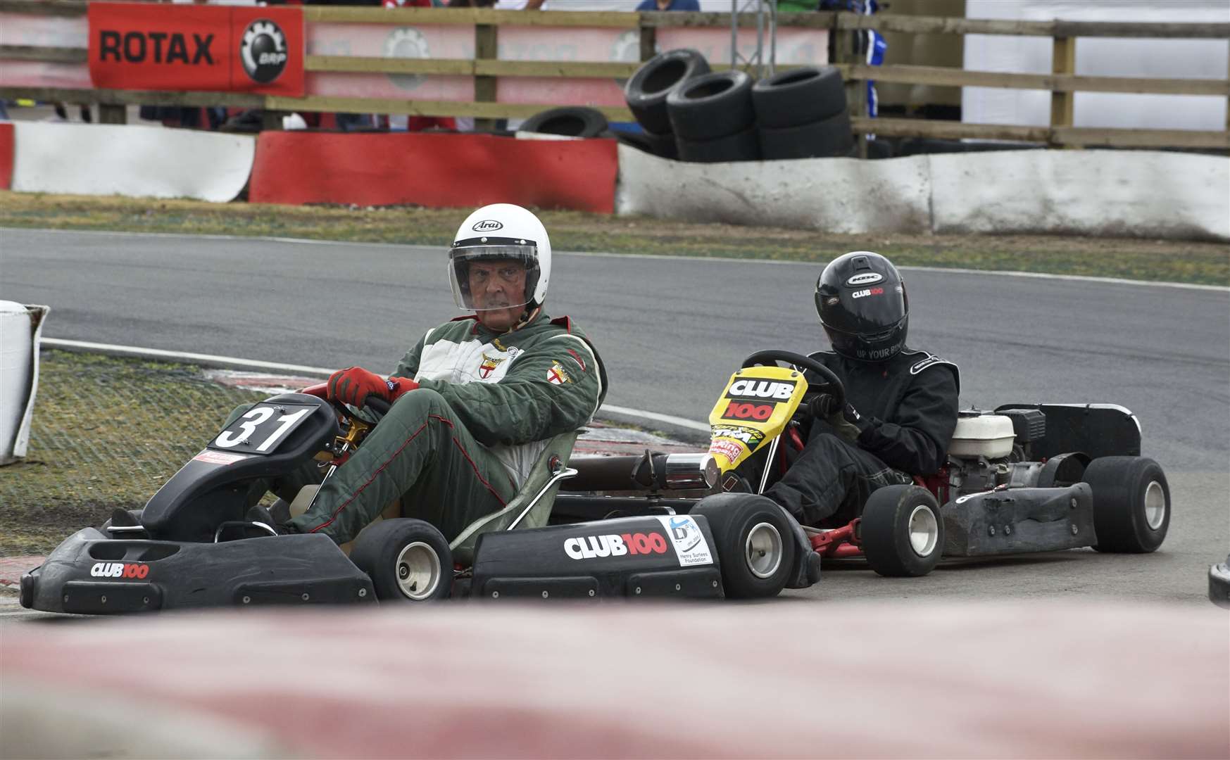 Former Kent County Council leader Sir Paul Carter, a keen historic racer, gets a push start after spinning in practice for the Henry's Headway Karting Challenge in 2010. Picture: Andy Payton