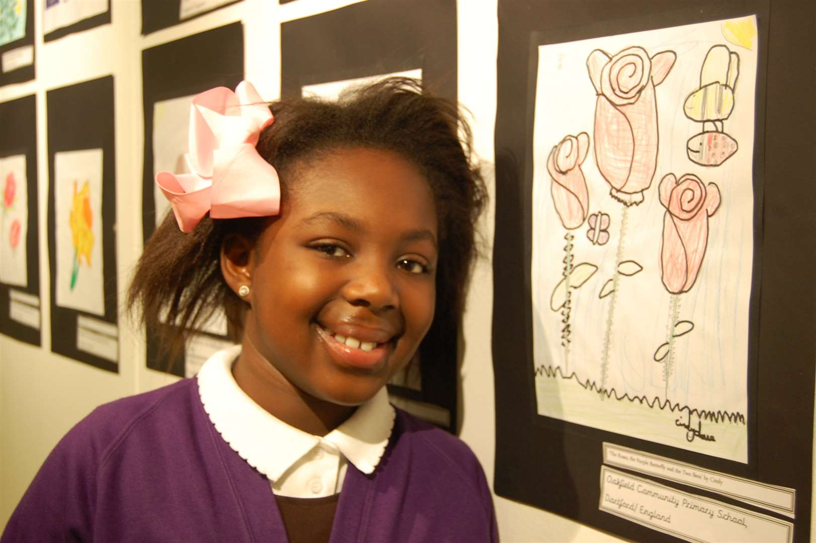 Cindy, 9, with her artwork dubbed 'The Roses, the Purple Butterfly and the Two Bees.