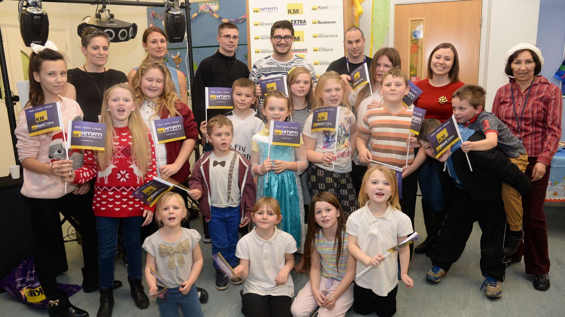 KMFM DJ Ben Pearce with children and staff at the Spring Lane Neighbourhood Centre Christmas party on Friday. Picture: Chris Davey FM3573258