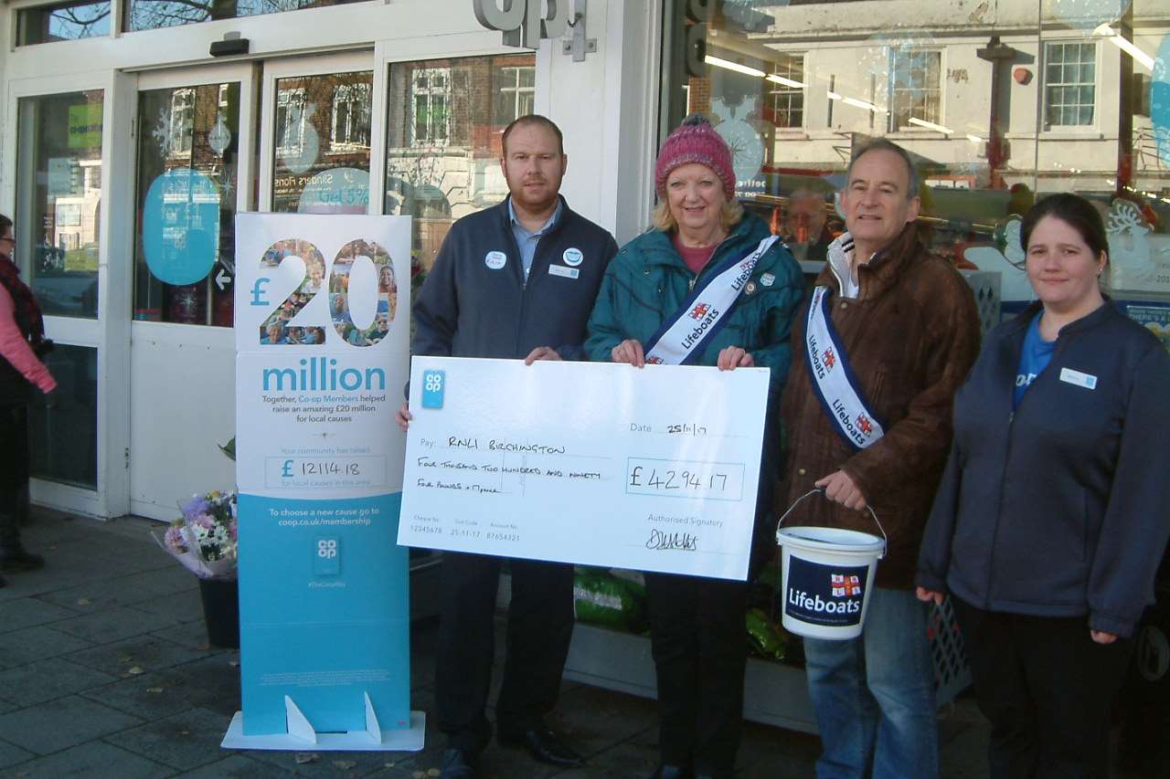 Co-op manager David Stubbs presents the cheque to RNLI chairman Phyllis Gulliver-Crane, with vice-chairman Richard and Co-op staff member Jessica
