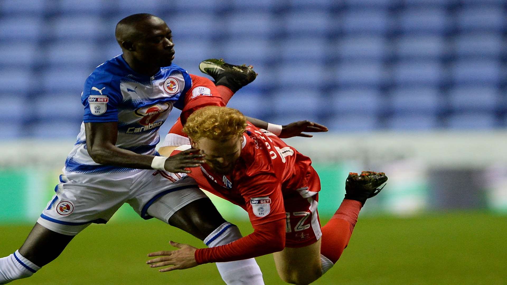 Gillingham’s Connor Ogilve challenges with Reading’s Modou Barrow. Picture: Ady Kerry