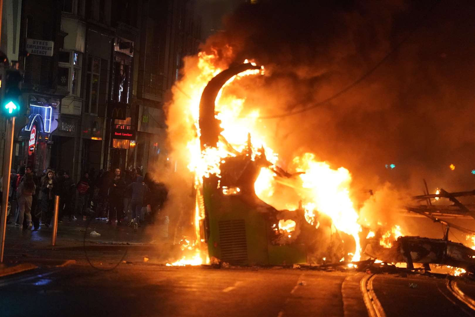 A bus on fire on O’Connell Street in Dublin city centre after violent scenes unfolded following an attack on Parnell Square East (Brian Lawless/PA)
