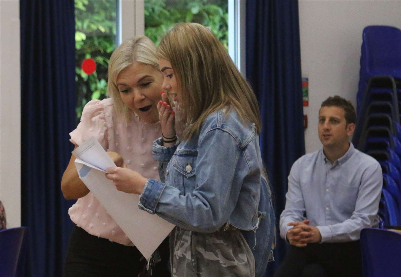 Tabitha De Garis discovers her GCSE results today at Aylesford School with mum looking on