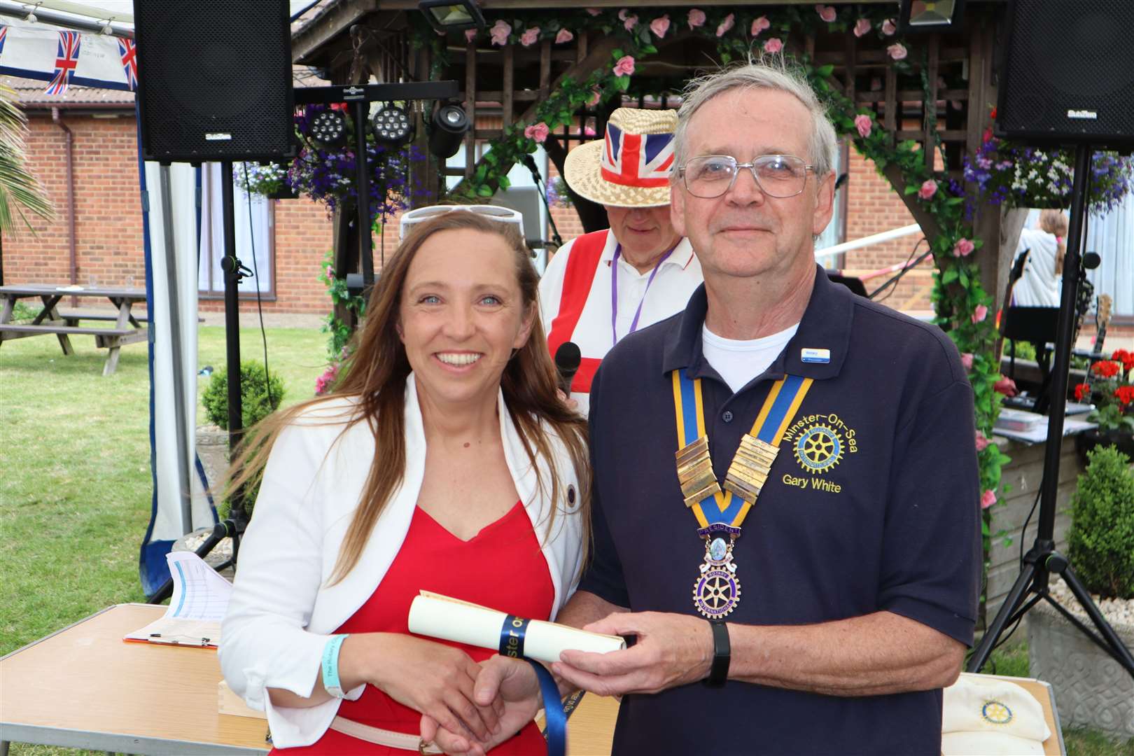 Becki Breiner of the Sheppey Song Signing Choir with Rotary president Gary White