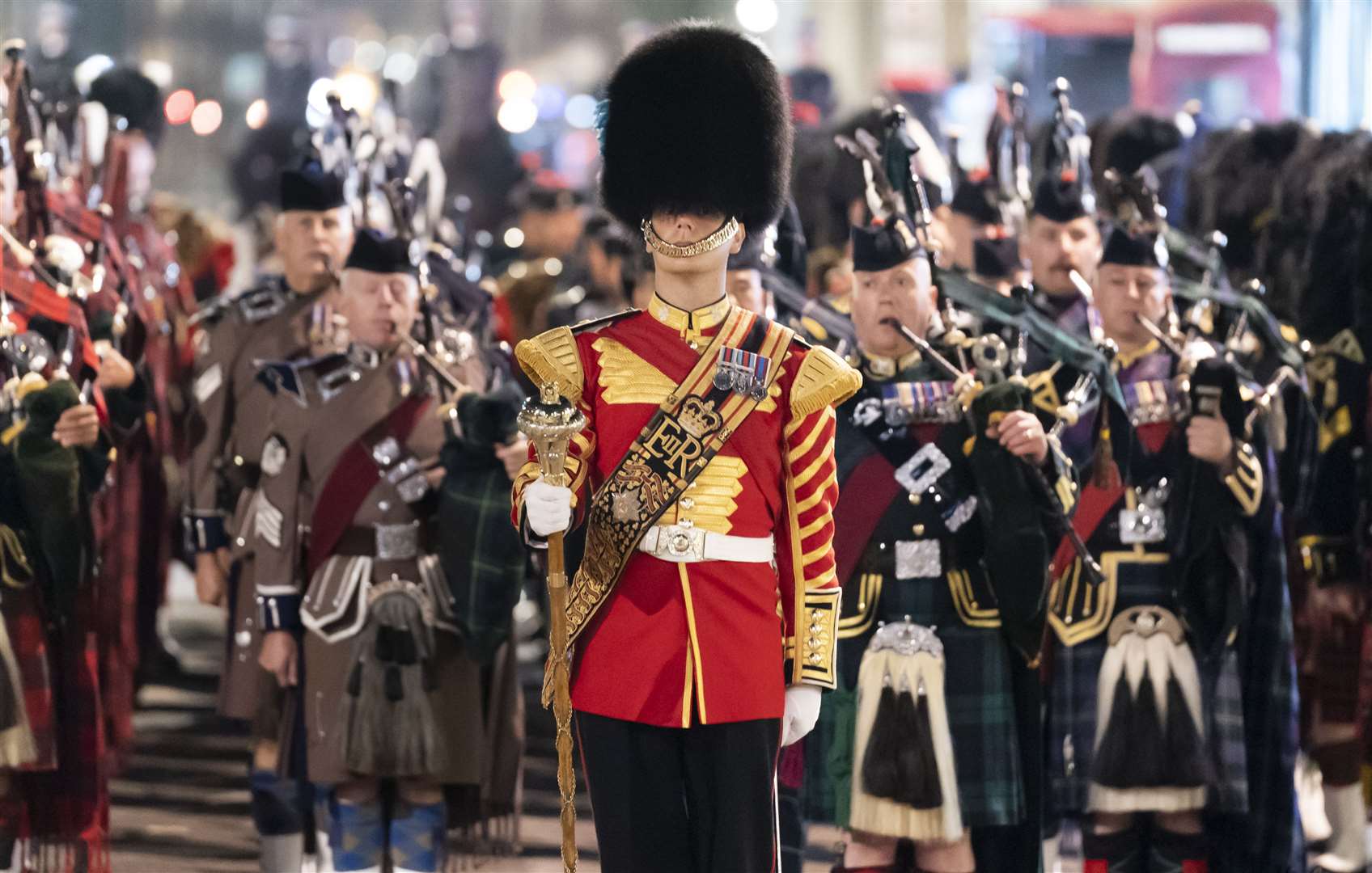The sound of bagpipes began at 2.45am, signalling the start of the procession and echoing through the quiet streets of London (Danny Lawson/PA)