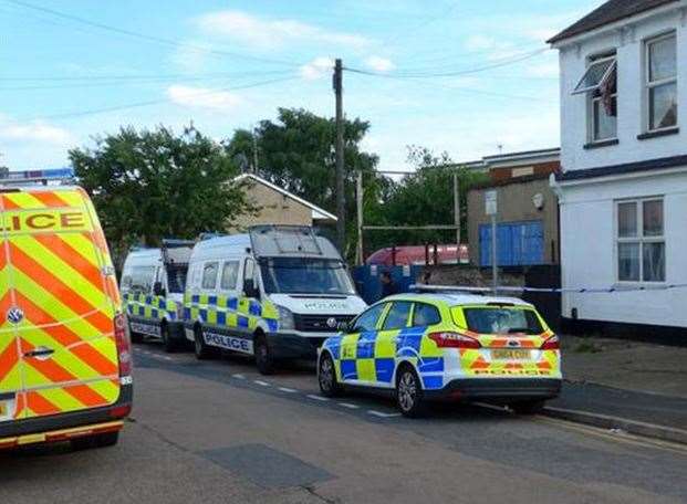 Police vehicles outside the home in Grove Road