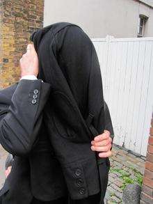 Carl Underdown hides his face as he leaves Canterbury Magistrates Court last Wednesday