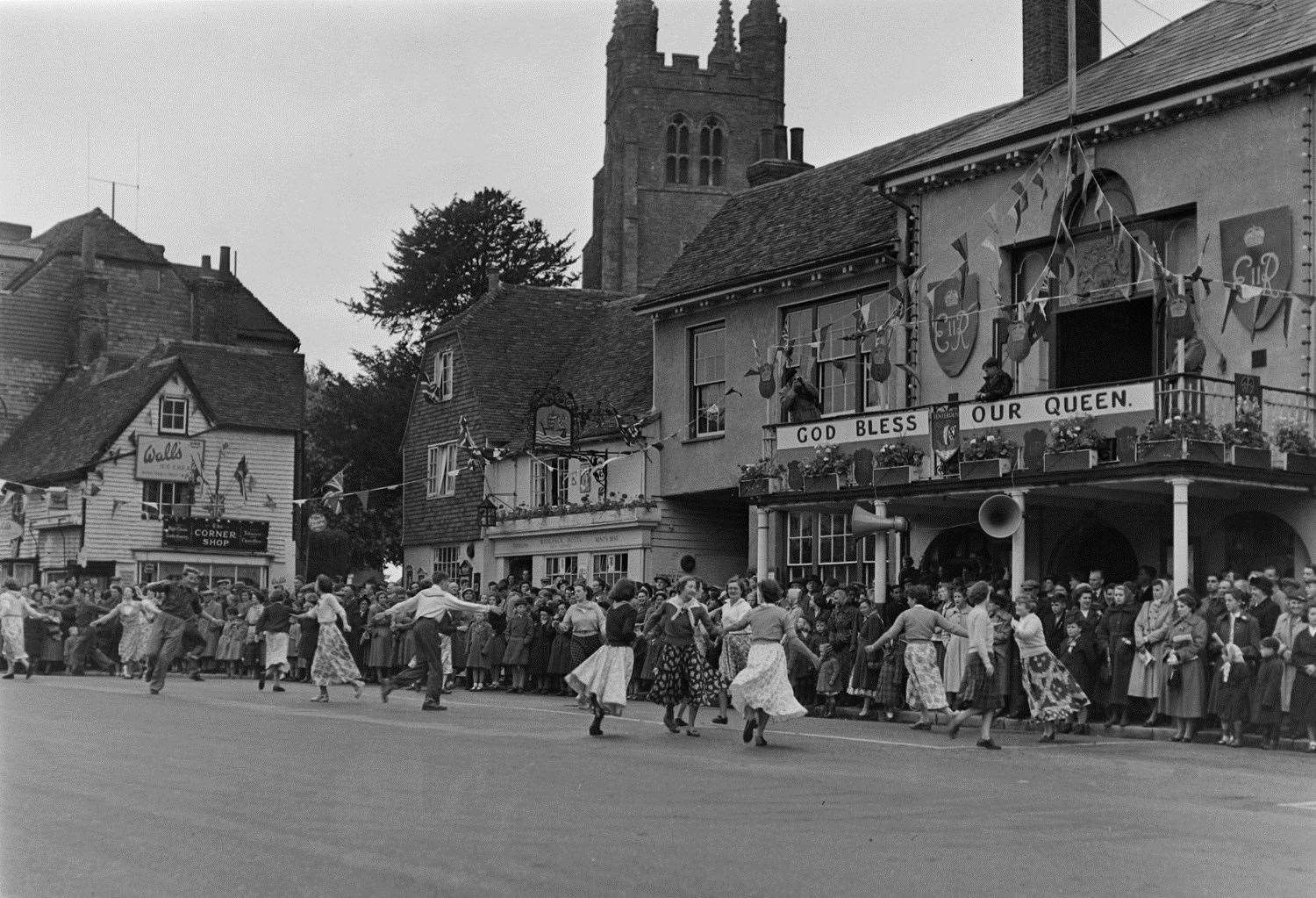 Tenterden residents dance outside The Woolpack and Town Hall as part of the 1953 Coronation celebrations. Picture: Steve Salter