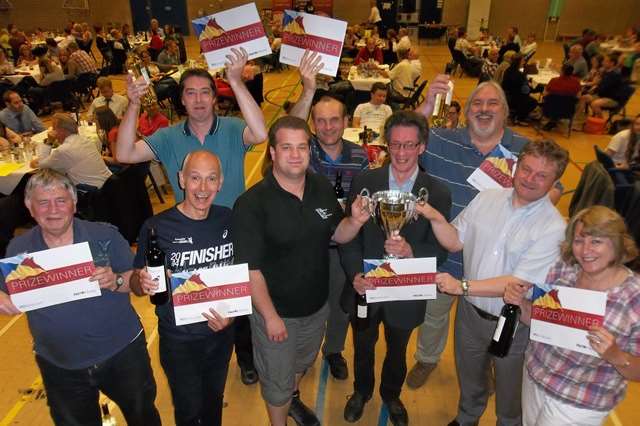 Phil Wilson of IMP and Mike Startup of DSH chartered accountants and business advisers present Supernova with the champions trophy at the Maidstone 2014 KM Big Charity Quiz trophy.