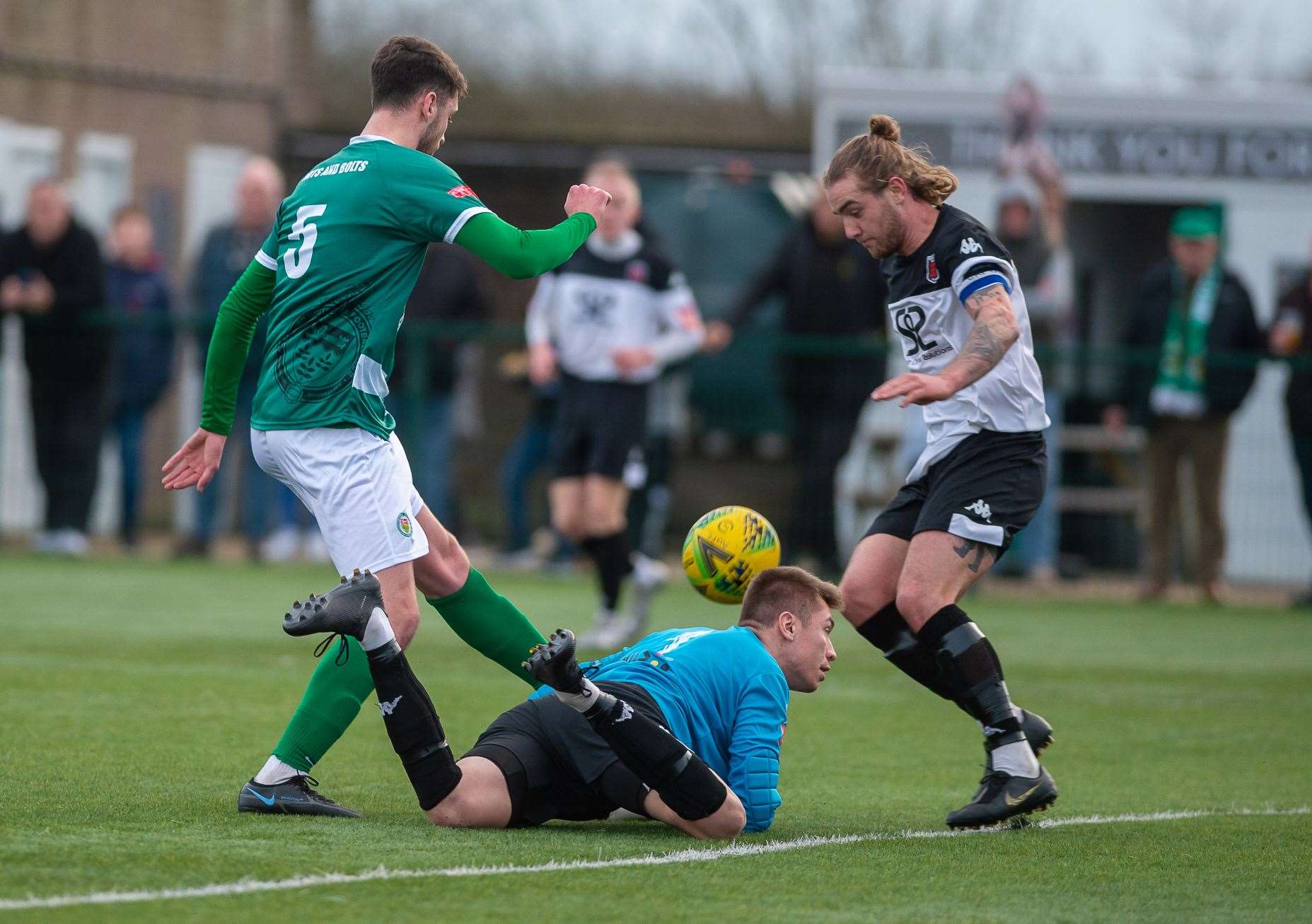 Ashford's Jack Steventon is denied by a combination of Faversham keeper Pat Ohman and defender Lewis Chambers Picture: Ian Scammell