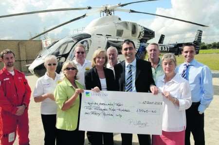 Kent Messenger Group events staff hand over money raised at events in the county to the Kent Air Ambulance