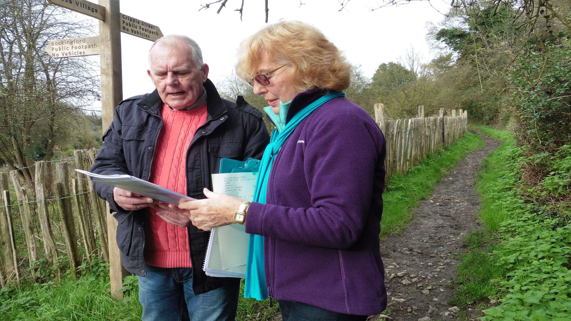 Cllr Hotson and resident Hilary Hunt examine the plans on the site of the proposed greenway