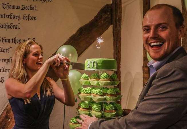 Amy McManus cuts a cake on AM Marketing's third birthday, watched by husband and business partner Bradley