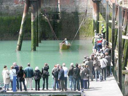 The replica of the Bronze Age boat is lowered into Dover Marina