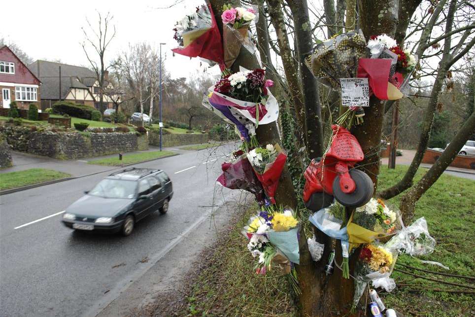 Floral tributes left on the bank and a tree in Bearsted