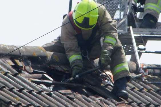 One of the firefighters inspecting the roof of the pub. Picture: Danny Mantle