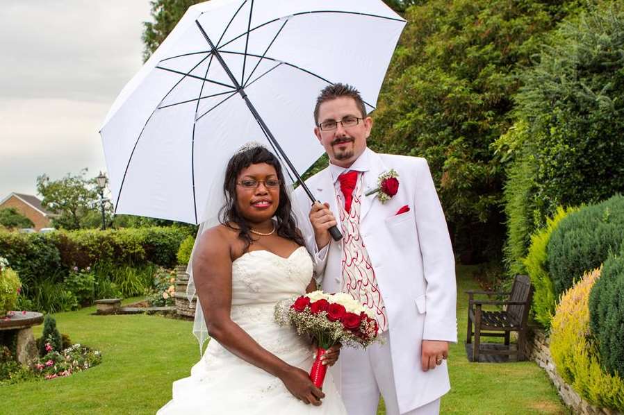 Husband and wife Pamela and Christopher Gale take shelter from the rain under an umbrella. Picture courtesy of www.bayimages.co.uk