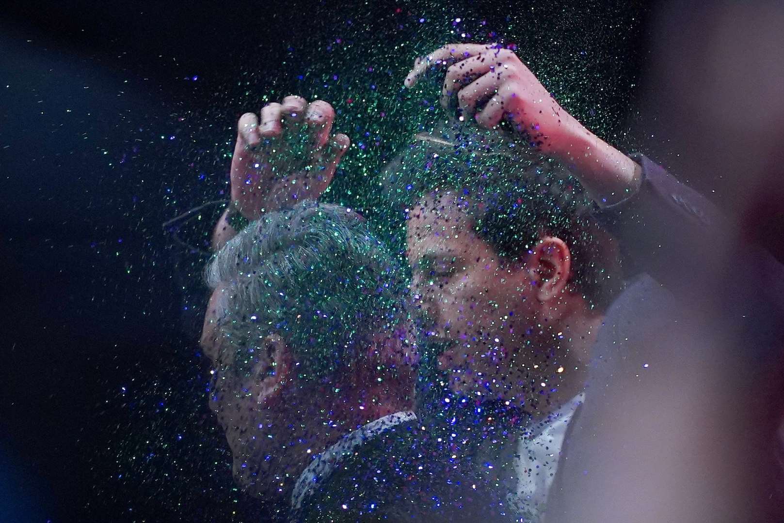 A protester throws glitter over Sir Keir Starmer (Peter Byrne/PA)