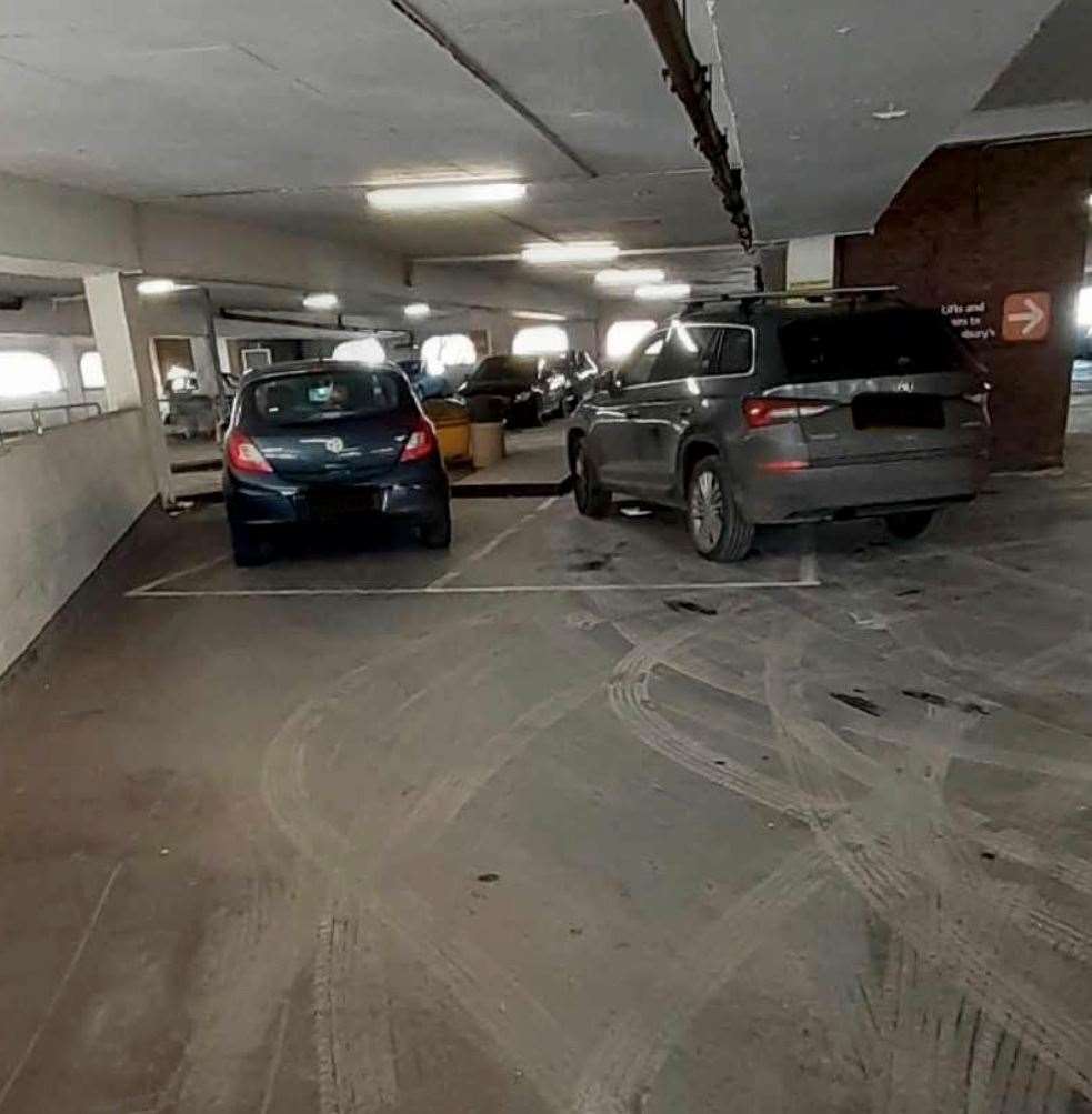 Two cars parked outside the white lines in Sainsbury's, Folkestone. Picture: S***e Parking Watch UK