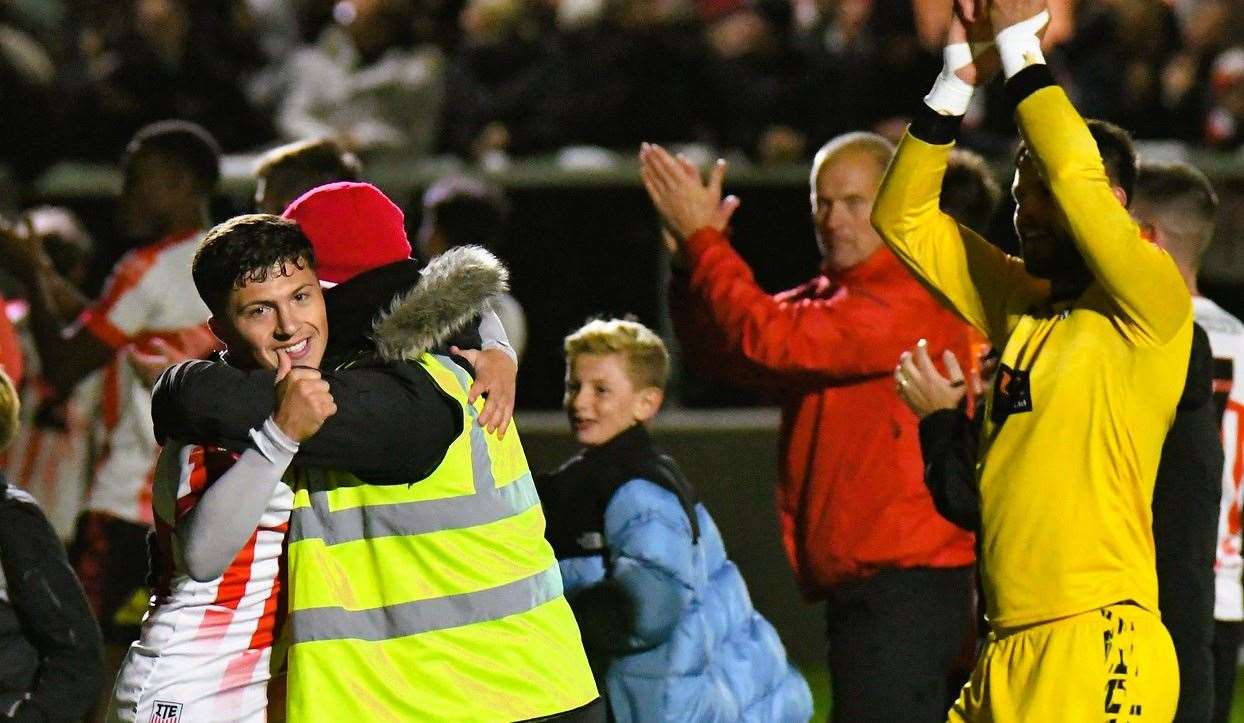Sheppey's Frankie Morgan gives the thumbs-up as he is embraced. Picture: Marc Richards