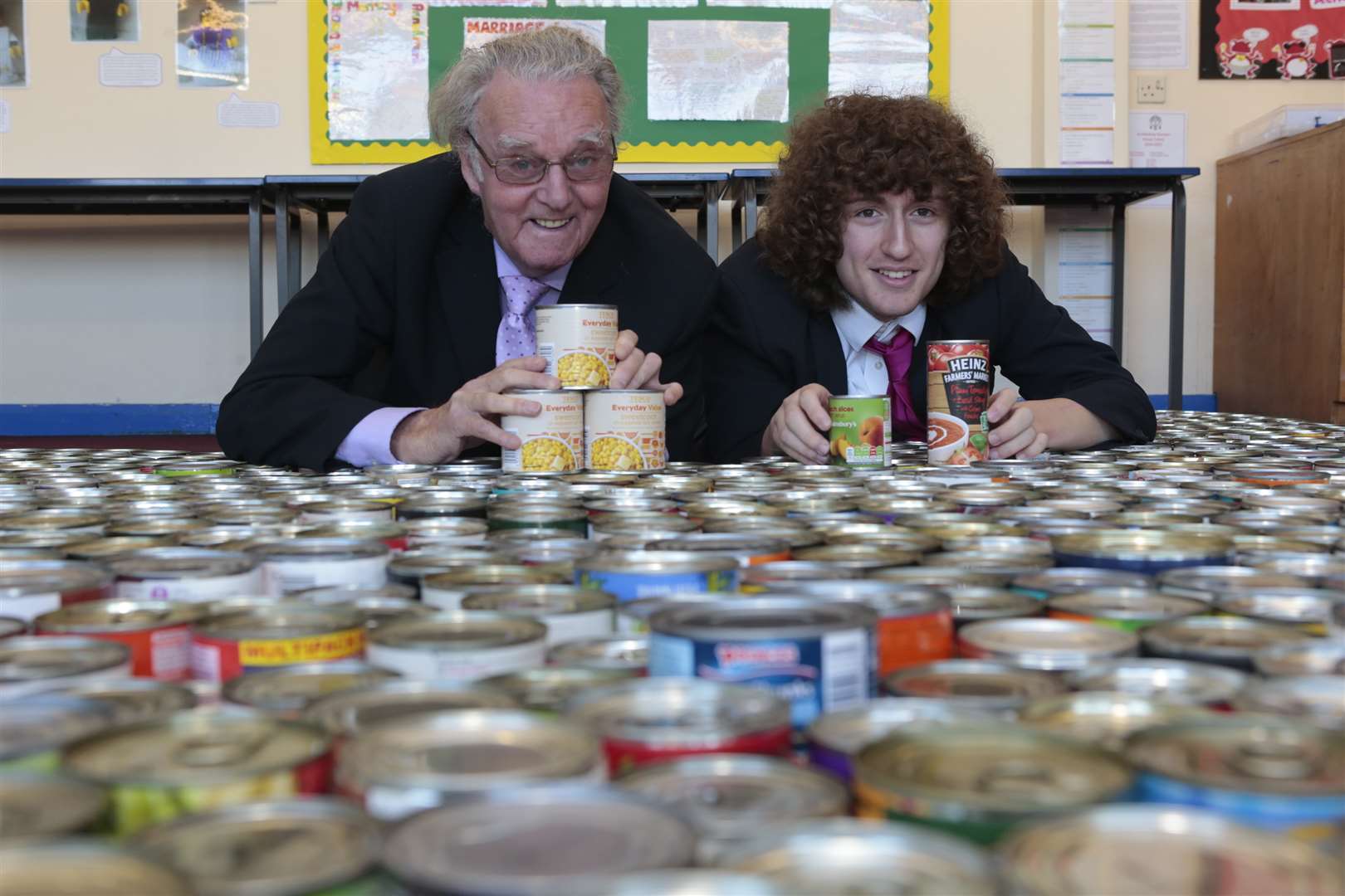 Maidstone Homeless Care trustee Mike FitzGerald with St Simon Stock sixth form student Ethan Wheeler - and 1,000 cans