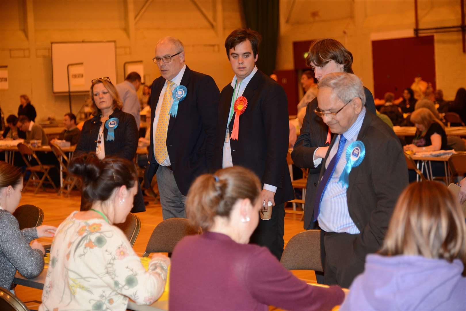 Campaigners look on as the ballot papers come in