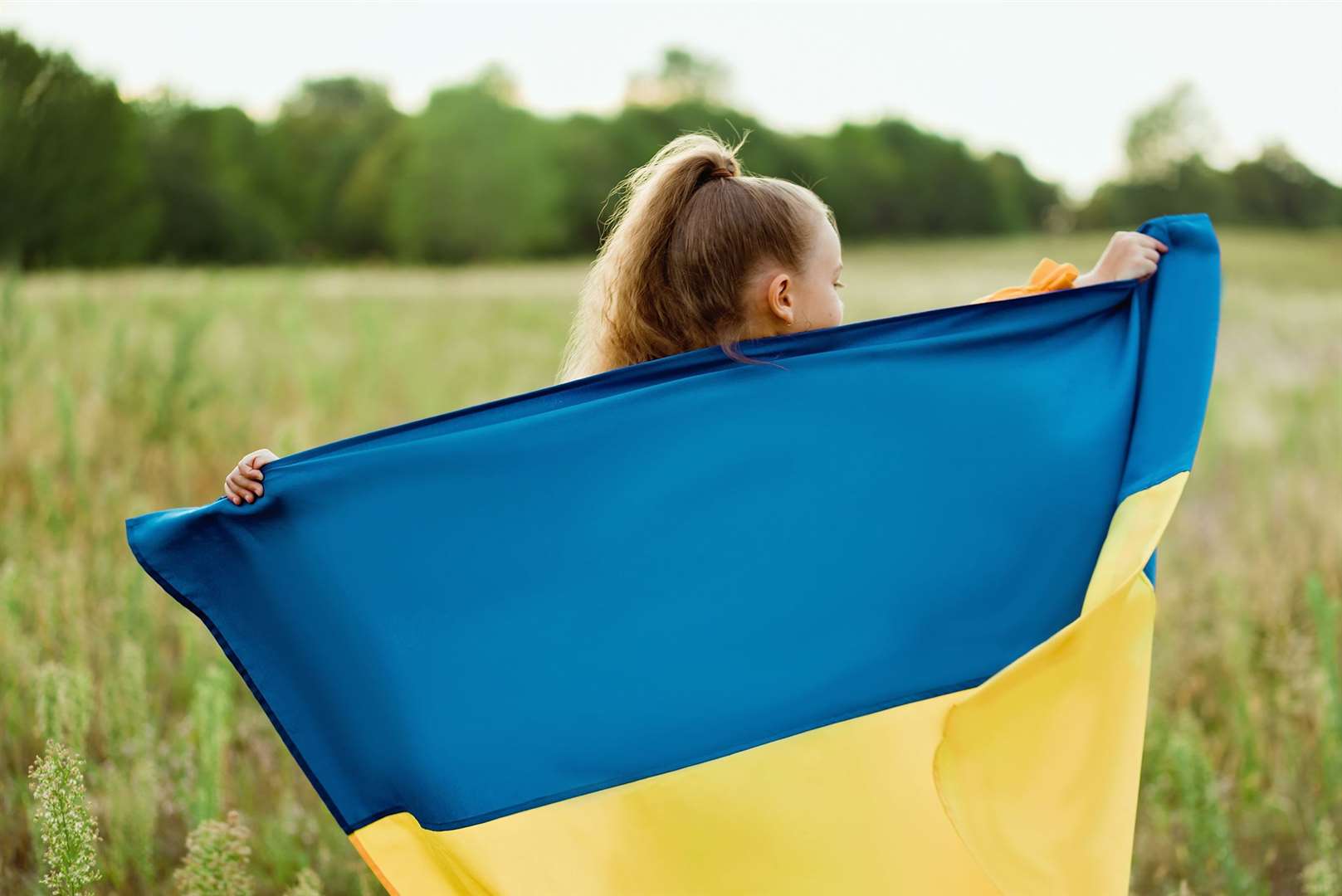 A Ukrainian child with her national flag. Image: istock