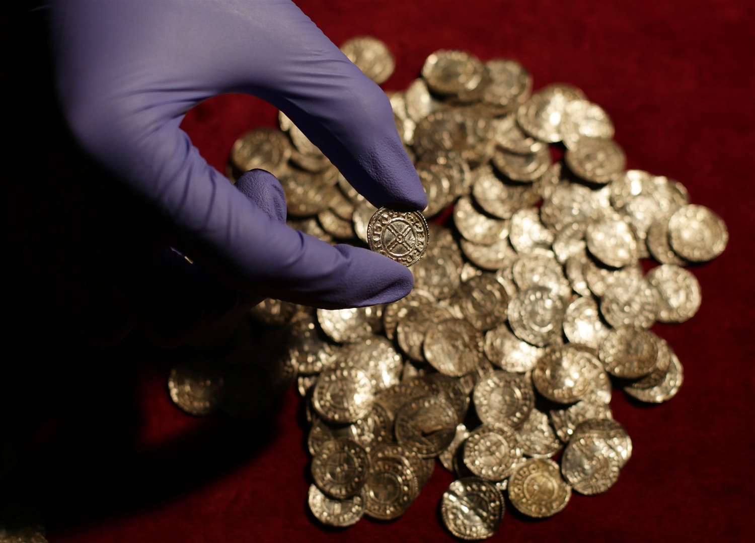 Some of the 5,200 coins discovered in the village of Lenborough, Buckinghamshire, the largest Anglo Saxon coin hoard found since the Treasure Act of 1996. Photo credit Yui Mok/PA Wire