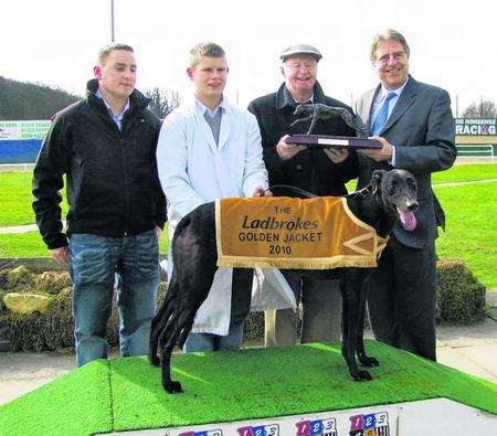 Group Skater's owner Daniel Greene is presented with the Ladbroke Golden Jacket trophy by David Evennett MP