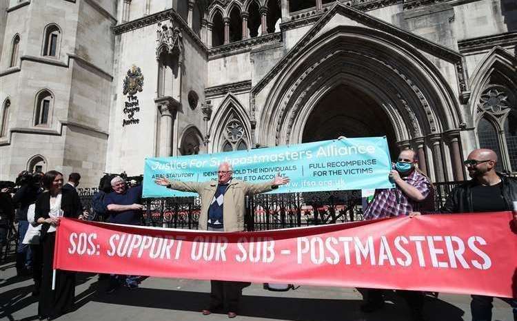 Sub-postmasters highlighting their case outside the Law Courts in London