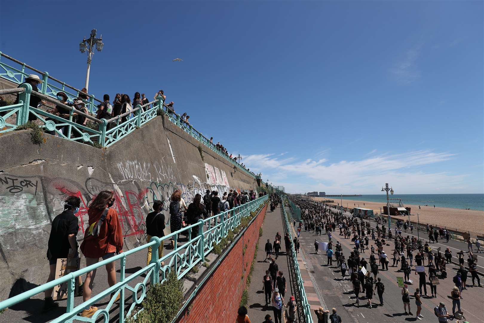 Protesters lined up along the sea front for the silent demonstration (Andrew Matthews/PA)