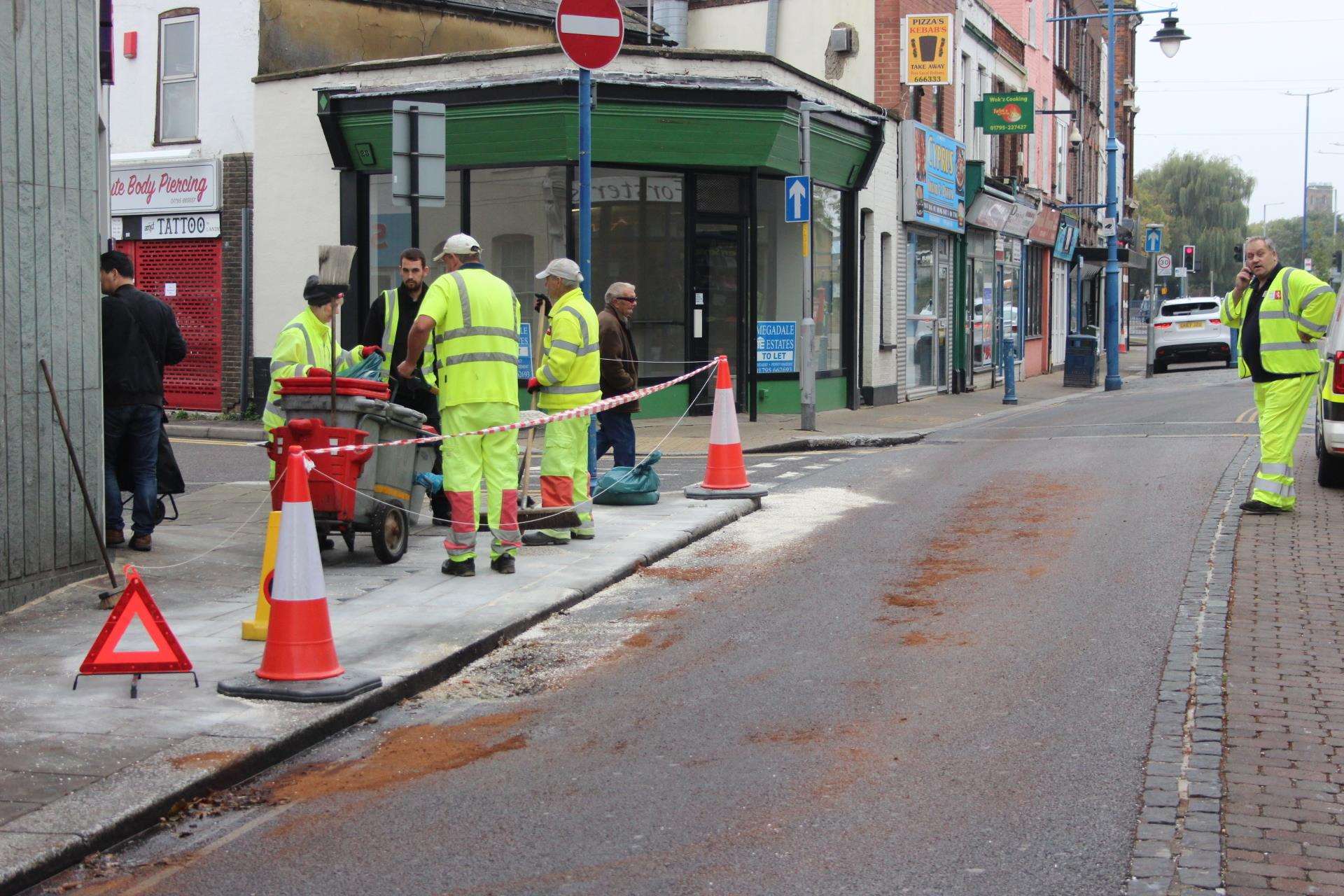 Workers cleaned up the pavement after a woman slipping on oil in Sheerness High Street on Monday