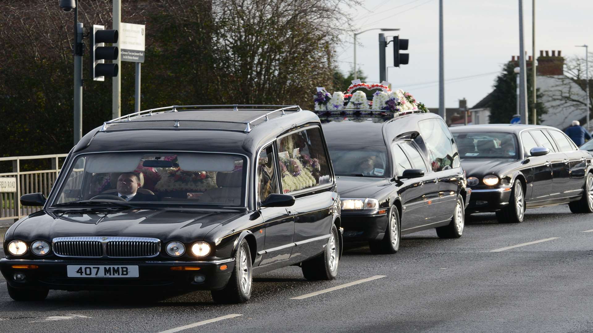 A procession of 12 limos and one funeral car headed to the church
