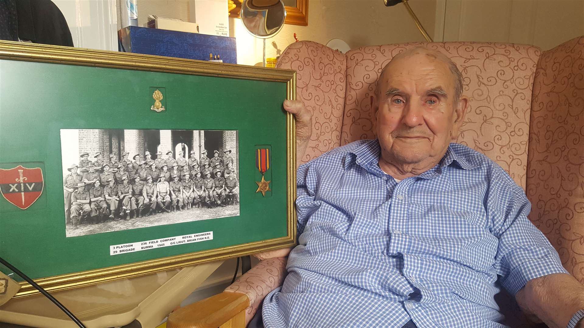Brian Fish with a picture of his platoon and his Burma Star medal